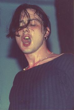 a man with his mouth open and tongue out