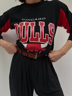 Our absolute favorite Chicago Bulls sweatshirt! Features the classic Chicago Bulls red coloring in the ribbed neckline and inner sleeves. The middle front of the sweatshirt showcases a beautiful print with the Chicago Bulls Logo. The perfect piece to pair with the AGOLDE 90's Pinch Waist Jean. 50% polyester 50% cotton Tag reads Official Licensed Product NBA - Made in USA Recommended for size xs-s, depending on the desired fit. Modeled on a small frame. Please refer to the measurements listed bel Retro Crew Neck Sweatshirt With Ribbed Cuffs, Red Long Sleeve Top With Ribbed Neckline, Varsity Crew Neck Top With Ribbed Collar, Retro Sweatshirt With Ribbed Collar And Long Sleeves, Varsity Graphic Print Top For Loungewear, Retro Long Sleeve Sweatshirt With Ribbed Collar, Retro Streetwear Tops With Ribbed Cuffs, Retro Fall Streetwear Tops, Crew Neck Tops With Ribbed Cuffs For College