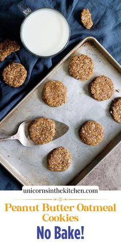 peanut butter oatmeal cookies on a baking sheet with a glass of milk