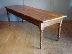 a wooden table sitting on top of a hard wood floor