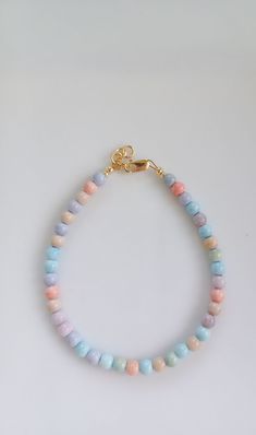 "Pastel Rainbow Bracelet. This bracelet is made with the semi precious Mongolia Alxa Rainbow Agate gemstone beads. These beads have been known to be healing. This unique and bold bracelet will catch the eye and is a unique accessory to complete any outfit! Wear it alone, or stack with multiple bracelets. It is handmade with high-quality materials that will last. All of our bracelets can be made for infant, toddlers, girls, teens, and women! PLEASE READ SIZING DETAILS BEFORE ORDERING: For the best fit, measure snug around the wrist with a measuring tape of a piece of string against a ruler. Then add 1/2 an inch and order the corresponding size from my recommended sizing chart. This ensures the most comfortable fit. Each bracelet comes with a 1/2 inch extender chain, so there is also room to Pastel Colorful Beads Bracelets As Gift, Pastel Beaded Bracelets For Gift, Pastel Bracelets With Colorful Beads For Gift, Pastel Beaded Bracelets Gift, Pastel Colorful Beads Bracelet As Gift, Adjustable Pastel Beaded Bracelet, Pastel Bracelet Jewelry As Gift, Adjustable Pastel Bracelets With Round Beads, Adjustable Pastel Beaded Bracelets As Gift