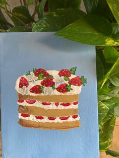 a piece of cake with strawberries painted on it