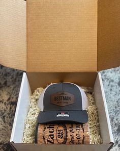 a box with two hats in it on top of a table next to a knife