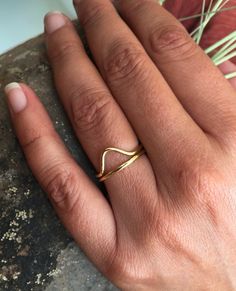 This is a triangle brass ring. V brass ring. A women's golden ring made of brass. It is an elegant and a minimalist design. It has a geometrical shape. It is very dainty, delicate and light wear.  A triangle represent strength, and can also represent concepts as past, present future or spirit mind and body.It is nickel free so it doesn't produce any allergies. It comes in a cute pouch so it is gift-ready.Urban jewelry, for those who not only want to wear special designs but also with meaning. Na Minimalist Yellow Gold Brass Ring, Minimalist Stackable Brass Rings, Minimalist Gold Brass Rings, Minimalist Brass Midi Rings For Everyday Wear, Minimalist Brass Midi Rings For Anniversary, Minimalist Brass Midi Rings For Everyday, Gold Brass Midi Rings In Minimalist Style, Gold Brass Midi Rings Minimalist Style, Minimalist Brass Stackable Rings