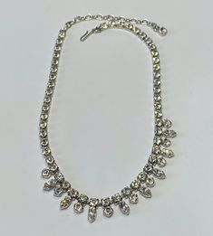 Beautiful silver tone and clear stone choker, perfect for a wedding, graduation or debutant.  This is a perfect accessory for that exciting night out.  This necklace is new new and has little to no signs of wear. Measurements:  42cm in total length, including the extender.  Square crystals are 0.5cm long and 0.5cm wide.  The round crystals are 0.5cm in diameter and the teardrop crystals are 1cm long and 0.5cm wide. Condition:  Excellent vintage condition.  No scratches, dents, or imperfections. Silver Adjustable Rhinestone Necklace For Formal Occasions, Classic Bridal Crystal Necklace For Parties, Classic Silver Choker For Wedding, Classic Bridal Necklace With Sparkling Stones For Party, Silver Party Choker With 17 Jewels, Adjustable Rhinestone Necklace For Wedding, Classic Silver Wedding Choker, Silver Choker With Sparkling Stones For Formal Occasions, Classic Silver Rhinestone Necklace For Wedding