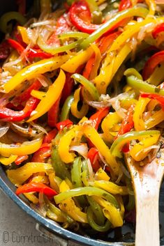 a skillet filled with peppers and onions