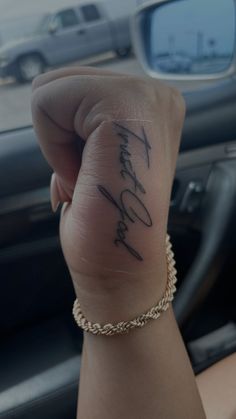 a woman's hand with a tattoo on it