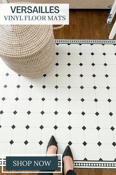 a woman standing on top of a floor next to a white and black tile pattern