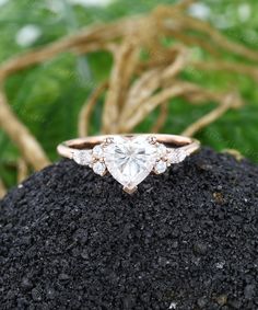 an engagement ring on top of a rock