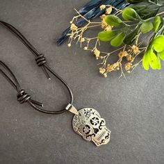 Unleash your edgy and unique style with our Rustic Silver Sugar Skull Necklace. Made with genuine brown leather cords and detailed with a metallic rustic silver tone sugar skull pendant, this necklace is sure to make a statement. It's adjustable, making it a perfect fit for any guy or brave girl looking to add some rock & punk fashion flair to their wardrobe. It adds a touch of edginess to any outfit and it exudes coolness and style. This unique piece is ideal for any occasion. Whether you're dressing up for a night out or getting into the Halloween spirit (if that's the season ☠️), this necklace is sure to make a statement. Upgrade your casual accessory game today! Frida Kahlo Earrings, Sugar Skull Necklace, Mexican Jewelry, Brave Girl, Rock Punk, Skull Necklace, Skull Pendant, Casual Accessories, Halloween Spirit