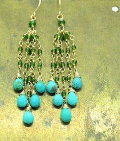 "Genuine Turquoise and Chrome Diopside Long dangle tassel gold filled earrings . These Boho style long earrings feature a beautiful turquoise natural drops beads and tiny Chrome Diopside gems, hand wire wrapped with 14k gold filled wire, dangling at the bottom of 14k gold filled French Hooks. Light, dangly, with shimmery stones these are an elegant and feminine, chic statement earrings, perfect for special occasion, wedding, holidays or casual wear. Mesurements: The earrings drop around 2.25\" f Green Dangle Chandelier Earrings With Latkans, Elegant Turquoise Jewelry With Latkans, Elegant Turquoise Earrings With Dangling Beads, Green Bohemian Long Drop Earrings, Turquoise Dangle Earrings With Colorful Beads, Handmade Turquoise Briolette Earrings, Turquoise Dangle Earrings With Gemstone Accents, Turquoise Wire Wrapped Teardrop Dangle Earrings, Adjustable Turquoise Earrings With Faceted Beads