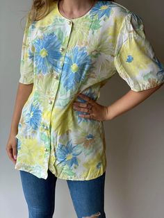 Vintage Lindex floral yellow and blue blouse in Hawaiian style for women. Retro 80s style, buttons closure light and perfect for summer and spring.  It will fit classic pants, jeans, and even a skirt. Casual style both for everyday wear and special occasions. Materials: 100% cotton Size: 40-42 / L-XL for women Era: 80s Pattern: floral Measurements: Breast 50 / 19,6 inches Waist 42 / 16,5 inches Hips 50 / 19,6 inches Length 76 / 29,9 inches The blouse is pre-owned, but it is in perfect condition. Summer Floral Print Button-up Blouse, Summer Half Sleeve Cotton Blouse, Summer Cotton Blouse, Half Sleeve, Retro Short Sleeve Tops For Summer, Summer Cotton Blouse With Half Sleeves, Yellow Half Sleeve Summer Blouse, Summer Vintage Print Relaxed Fit Shirt, Vintage Print Relaxed Fit Summer Shirt, Floral Print Half Sleeve Shirt For Spring