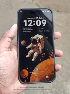 someone is holding up their cell phone with an image of an astronaut on the screen