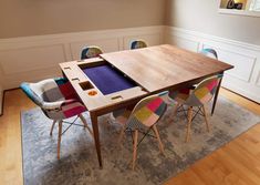 a wooden table with colorful chairs around it