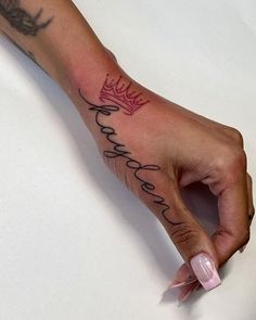 a person's hand with a tattoo that says, king and queen on it