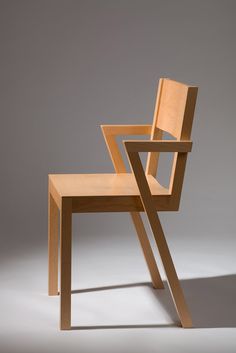 a wooden chair sitting on top of a white floor