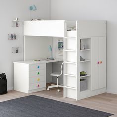 a white and blue loft bed with desk