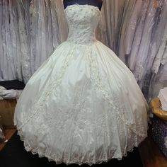 a white wedding dress sitting on top of a table