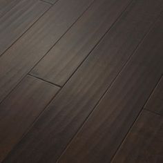 wood flooring that looks like it has been painted in dark brown and is very shiny