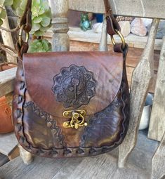 Vintage Hand Tooled Flowers Leather Saddle Bag Boho Hippie.  Please see pictures for condition.  This bag is in used condition. There are some scuffs and small stains to the leather. There is some staining inside. Leather is still very solid. Nice braided strap I leather oiled this bag and reconditioned the leather....the leather is thick and solid very good condition, except the staining in the inside which does not change this bags uniqueness and beauty. Measurements are 8 inches tall, 9 inche Antique Brown Leather Bags, Antique Leather Bags For Everyday Use, Leather Satchel Saddle Bag For Festivals, Brown Leather Saddle Bag For Festival, Antique Satchel Bag, Antique Satchel Bag For Everyday Use, Bohemian Leather Saddle Bag, Antique Handmade Bag For Everyday Use, Antique Leather Bag