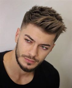 a close up of a person wearing a black shirt and a short haircut with an undercut