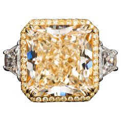 a fancy yellow diamond ring with two diamonds on each side