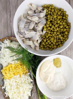 two bowls filled with different types of food on top of a wooden table next to each other