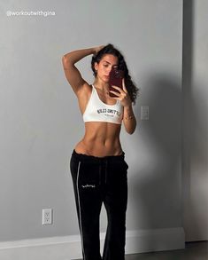 @workoutwithgina is showing off her strong core in the lifting club retro bra and velour joggers