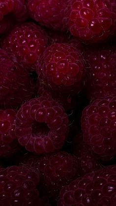 raspberries with water droplets on them are shown in this close up photo,