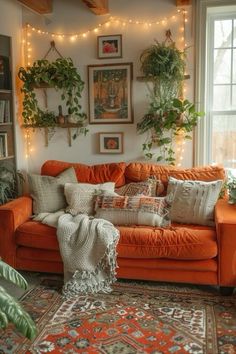 a living room with an orange couch and potted plants