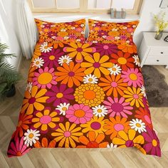 an orange and pink bed with flowers on it