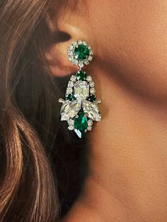 The CEMILE Earrings with Emerald Colored Swarovski Crystals that are filled with different shaped crystals gives off and amazing glamourous look. The perfect statement piece to add a hint of color to your look! The shine on these earrings are impeccable. Handcrafted with the Highest Quality Materials Swarovski Crystals Crystals Color: White & Emerald Colored Crystals Platinum plated - Guards against scratches and tarnish. Approx. Length 2" Approx. Width 1" Hypoallergenic & Nickel free Evening Jeweled Crystal Bridal Earrings, Evening Bridal Jeweled Crystal Earrings, Evening Bridal Crystal Earrings, Glamorous Jeweled Crystal Bridal Earrings, Jeweled Crystal Earrings For Formal Occasions, Formal Crystal Earrings Jeweled, Formal Jeweled Crystal Earrings, Glamorous Crystal Cluster Earrings, Evening Jeweled Crystal Earrings