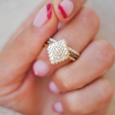 a close up of a person's hand with a ring on their finger and nails