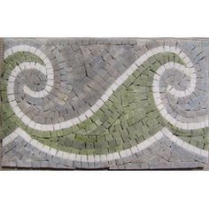 a tile wall hanging with green and white designs on it