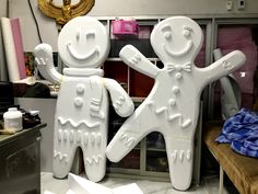 two large white figures standing next to each other