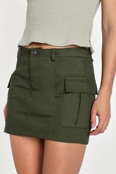 It's easy to see yourself topping every ""best dressed"" list in the Lulus Trendsetting Aura Olive Green Cargo Mini Skirt! Stretchy woven twill shapes this Y2K-inspired mini skirt that will have the compliments coming your way with its high waist, belt loops, and a hidden zip fly with top button closure. Utility pockets accent the sides, finishing at a mini hem. Length: Above mid-thigh. Size small measures 14.50" from waist to hem. Fabric: Fabric has some stretch. Unlined. 97% Cotton, 3% Spandex Green Cargo Skirt With Pockets, Casual Green Cotton Cargo Skirt, Trendy Khaki Cargo Skirt For Summer, Green Utility Skirt For Summer, Green Utility Skirt For Spring, Trendy Green Cotton Skort, Mini Cargo Skirt With Pockets For Day Out, Green Cotton Mini Skirt For Work, Trendy Green Cotton Skirt