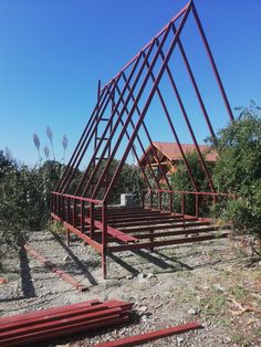 a metal structure sitting on top of a dirt field