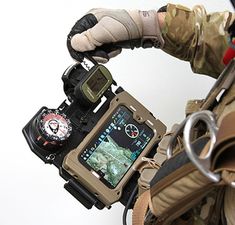 a man in camouflage holding a camera with his arm wrapped around him and wearing gloves