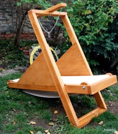 a wooden chair that is sitting in the grass