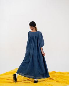 Crafted from the finest handloom cotton, this elegant dress features a classic checkered pattern and is dyed with natural indigo. Versatile and effortless, the peasant-style dress boasts balloon sleeves and can be worn in a variety of fashionable ways. Ethically hand-crafted by our artisans in West Bengal. The Fabric ages gracefully, becoming softer with every wash. Consciously crafted — low-impact dyeing Designed and made in India. Garment measurements Small : Length: 24.5", Chest: 45" Shoulder Indigo Cotton Day Out Dress, Blue Unstitched Cotton Dress, Long Sleeve Indigo Cotton Dress, Oversized Blue Cotton Dress, Peasant Style Dress, Indigo Midi-length Cotton Denim Dress, Betty Dress, West Bengal, Peasant Style