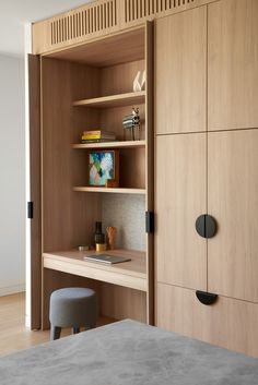 a bedroom with a bed, desk and bookcase in the closet next to it