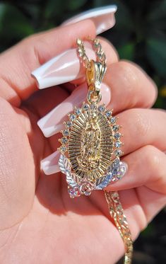 This Virgin Mary Necklace features the Virgin Mary apparition of Mexico within an oval medallion surrounded by rhinestones. This necklace is so simple yet so elegant. Pendant Height: 1.25" inches 18" chain Includes 14K gold plated chain Gold Oval Jewelry With Rhinestones, Gold Oval Rhinestone Jewelry, Mary Necklace, Virgin Mary Necklace, The Virgin Mary, Elegant Pendant, Blessed Mother, Gold Plated Chains, Virgin Mary