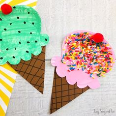 two ice cream cones with sprinkles on them