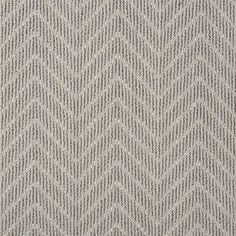 an upholstered gray and white rug with zigzag pattern