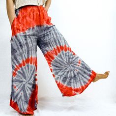 Tie Dye Boho Palazzo Pants, Wide Leg Tie Dye Trouser, Summer Pants, Beach Wear, Boho Flowy Pants,  Plus Size Pant with Pockets,Festival Pant  This boho-style Palazzo Pant is handmade with a unique tie-dye pattern. It's perfect for beachwear or as a statement piece for festivals and special occasions. Stand out from the crowd with these stylish and vibrant pants. Handmade Material: Rayon Adjustable Waist Two Side Pockets Red Bottoms With Elastic Waistband For Festivals, Hippie Style Relaxed Fit Bottoms For Festival, Red Elastic Waistband Bottoms For Festival, Red Festival Pants With Elastic Waistband, Bohemian Red Harem Bottoms, Bohemian Wide-leg Pants With Pockets, Red Bohemian Harem Bottoms, Casual Wide-leg Pants For Festivals, Red Bohemian Bottoms With Elastic Waistband