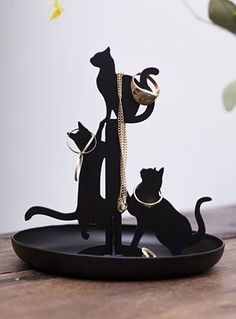 a cat and dog figurine on a black tray