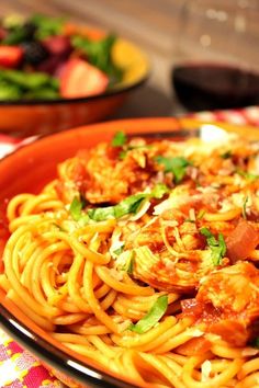 a plate of spaghetti with meat and vegetables