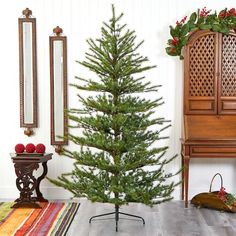 a small christmas tree sitting in the corner of a room