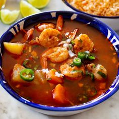 a bowl of shrimp and vegetable soup with rice