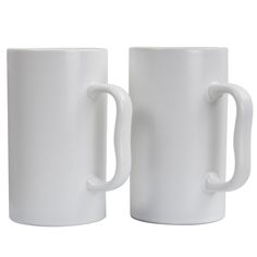 two white coffee mugs sitting next to each other on a white surface with handles